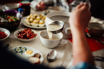 Midsection of person preparing food on table