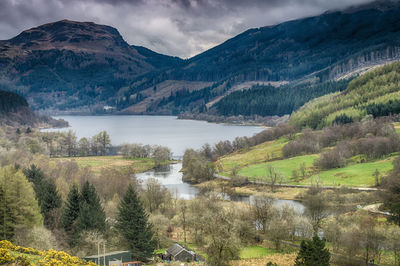 Scenic view of lake and mountains against sky