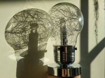 Close-up of light bulb against the wall