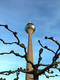 Low angle view of tower against cloudy sky