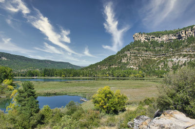 Scenic view of lake and mountains against sky