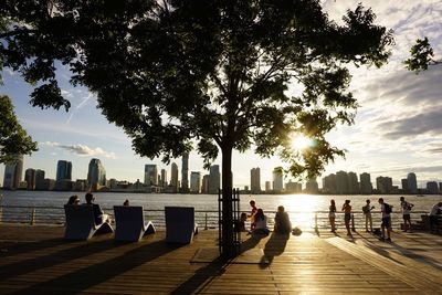 People at promenade in city against sky