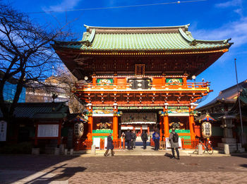 Group of people outside temple against building