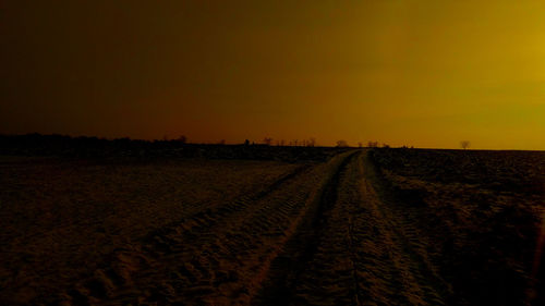 Scenic view of field against sky during sunset