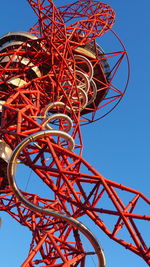 Low angle view of ferris wheel against clear blue sky