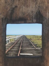 View of railroad track through window