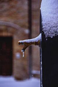 Close-up of frozen faucet during snow