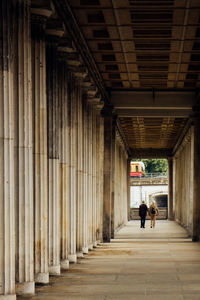 People walking under corridor