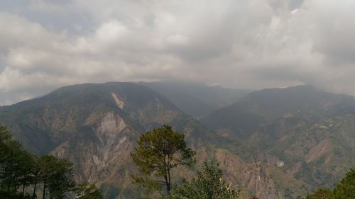 Scenic view of mountains against cloudy sky