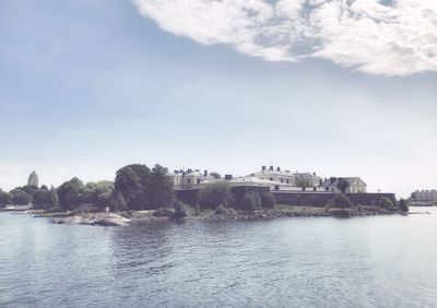 Castle ruins by the sea on island against bright sky