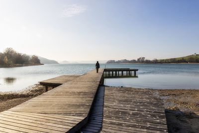 Pier over lake against sky