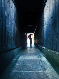 Woman walking in tunnel