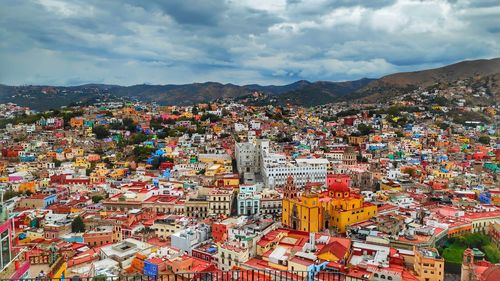 High angle view of city against cloudy sky