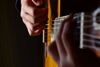 Youngster playing classic guitar. closeup of hands 