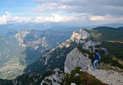 Man looking at mountain range against sky