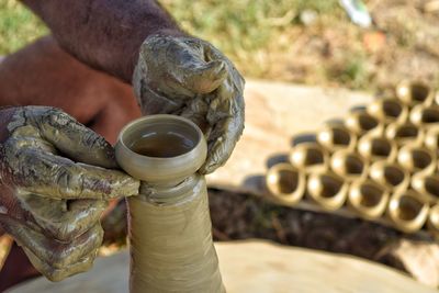 Midsection of man making pottery