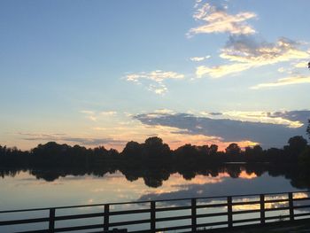 Scenic view of river against sky at dusk