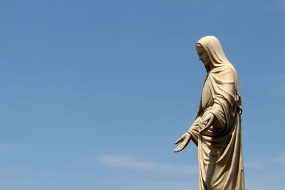 Low angle view of statue against sky