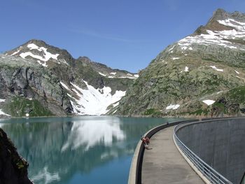 Dam against rocky mountains