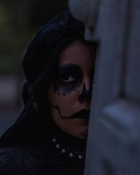 Close-up portrait of young woman with mask