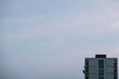 Low angle view of building against cloudy sky