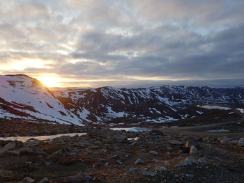 Scenic view of snowcapped mountains against sky during sunset