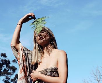 Low angle view of woman against sky