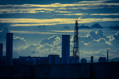 Buildings against cloudy sky