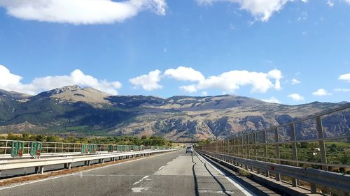 Railroad tracks leading towards mountains