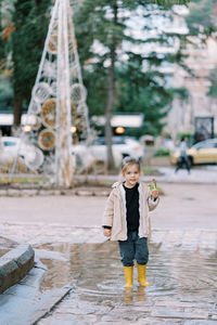 Portrait of young woman walking on street