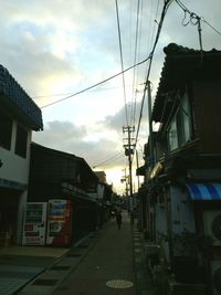 Road amidst buildings in city against sky