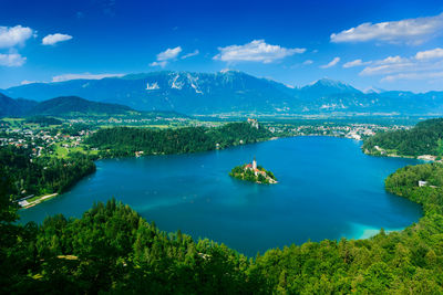 Scenic view of lake and mountains against blue sky