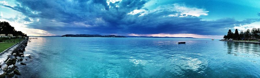 View of swimming pool in sea against cloudy sky