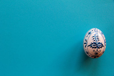 High angle view of ball on table against blue background