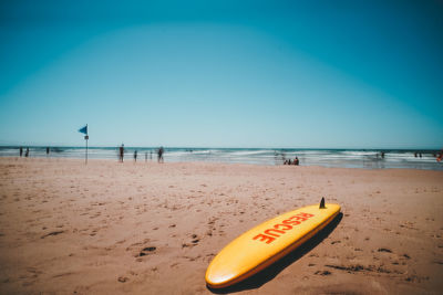 Scenic view of beach against clear blue sky