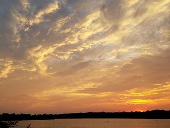 Scenic view of calm lake at sunset