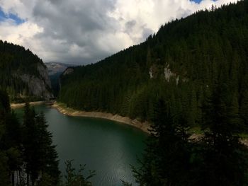 Scenic view of lake and mountains against sky