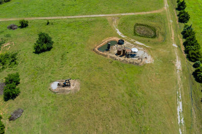 High angle view of tire tracks on field