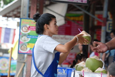 Portrait of young woman holding food