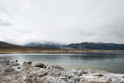 Calm lake against mountain range