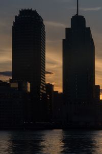 Modern skyscrapers against sky during sunset