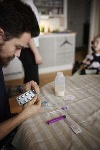 Man preparing nutrition for feeding tube for disabled child