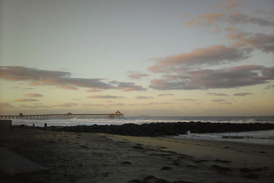 Scenic view of beach against sky during sunset