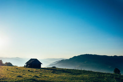 Hut of field against clear sky