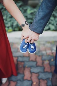 Midsection of couple holding hands