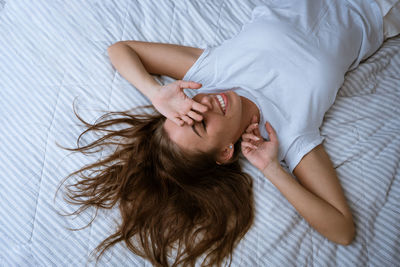 Midsection of woman sleeping on bed