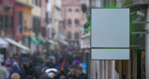 Close-up of people on street against building