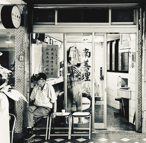 Man sitting on chair at store