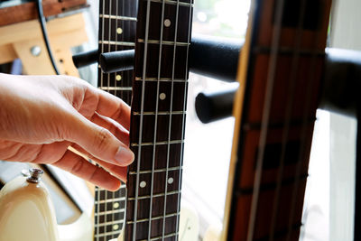 Close-up of hand playing guitar