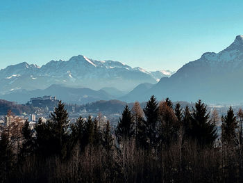 Scenic view of mountains against clear blue sky